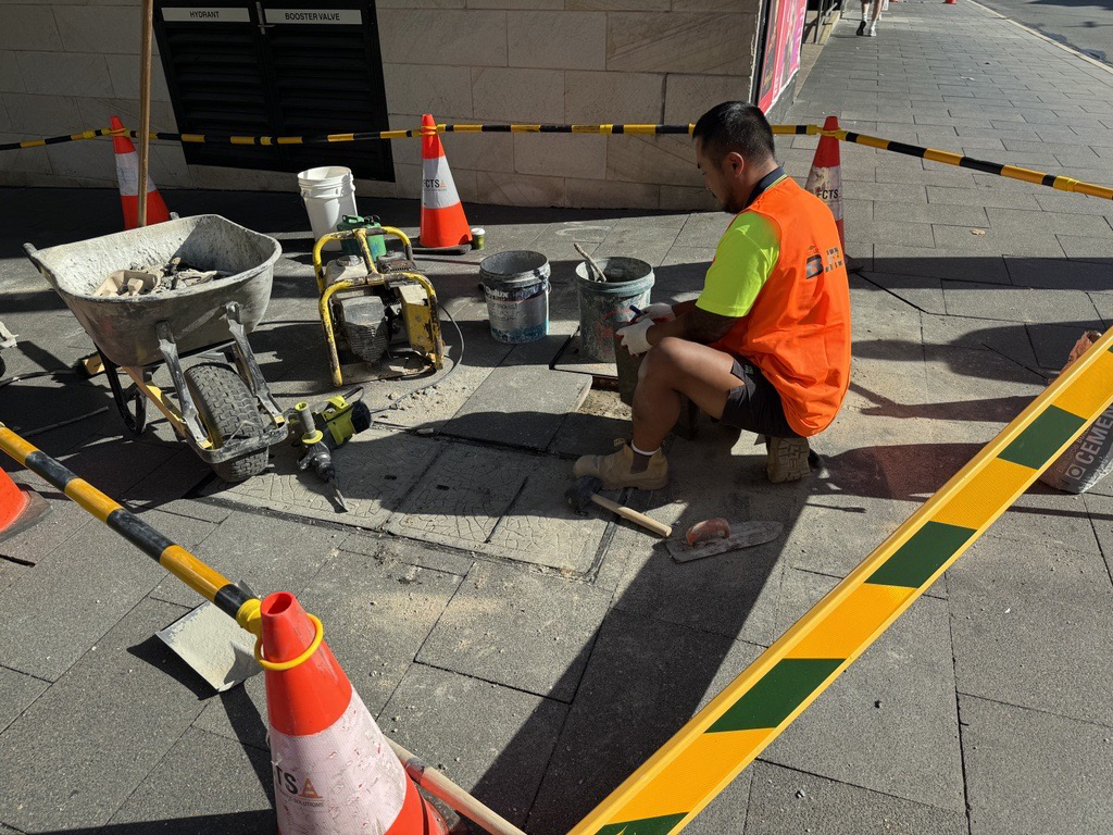 Image of a man fixing pavements