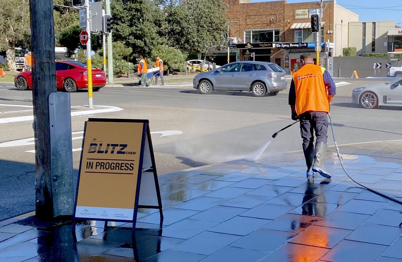 An image of a man steam cleaning pavements in Malabar.